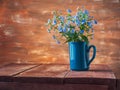 Banner with spring primroses, bouquet forget-me-not in mug