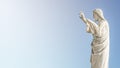 Banner with a statue of Jesus Christ praying at the church of Notre Dame de la Garde in Marseille, France, blue sky, smooth