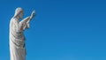 Banner with a statue of Jesus Christ praying at the church of Notre Dame de la Garde in Marseille, France, blue sky, smooth Royalty Free Stock Photo