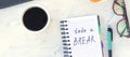 banner with Take a break. Concept time off. Words Take a break in a notebook on the working table with cup of coffee and Royalty Free Stock Photo