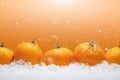 Banner with tangerines in the form of fur-tree toys on the snow, with falling snow. Happy Christmas or Happy New Year, orange