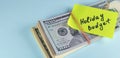 banner with text written note Holiday budget, dollars cash money in rubber band with note, on copy space background - Royalty Free Stock Photo