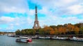 Travel in Paris with Eiffel Tower iconic Paris landmark across the River Seine with  tourist boat in  Autumn tree fall Royalty Free Stock Photo