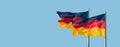 Banner with two national black red yellow flags of Germany at blue sky solid background with copy space, details, closeup. Concept