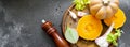 Banner vegetables on cutting board: orange squash, celery, garlic and spices - pepper. salt. Black background. Copy space Royalty Free Stock Photo