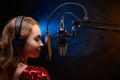 Banner. Vocalist sings in the studio. Practice and school of vocal. Music and teaching. Effective photo with blue and orange smoke Royalty Free Stock Photo