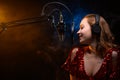 Banner. Vocalist sings in the studio. Practice and school of vocal. Music and teaching. Effective photo with blue and orange smoke Royalty Free Stock Photo
