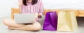 Banner website beautiful asian woman shopping online with laptop computer sitting on floor on room Royalty Free Stock Photo