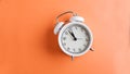 Banner white alarm clock on a colored orange background. Minimalism. Art concept of time, start, planning. Copy space