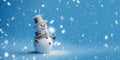 Banner with white snowman closeup on blue background, top view. Merry Christmas and Happy New Year holiday concept Royalty Free Stock Photo