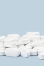 Banner of white tablets or pills on blue table. Medicine and pharmacy Royalty Free Stock Photo