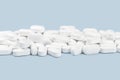 Banner of white tablets or pills on blue table. Medicine and pharmacy Royalty Free Stock Photo