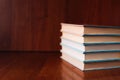 Banner with wide bookshelf and a stack of hardcovered books with bookmarks.