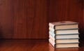 Banner with wide bookshelf and a stack of hardcovered books with bookmarks.