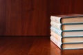 Banner with wide bookshelf and a stack of hardcovered books with bookmarks.