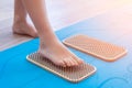 banner. Women feet are standing on a board with sharp nails, Sadhu Board. yoga practice. sun exposure, rays. blue mat Royalty Free Stock Photo