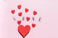 Banner.The word Love.Black letters Love with Red hearts.on pink background.Valentine's day. Loving, positive emotions Royalty Free Stock Photo