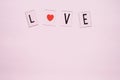 Banner.The word Love.Black letters Love with Red hearts.on pink background.Valentine's day. Loving, positive emotions Royalty Free Stock Photo