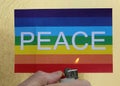 banner with word peace and hand with lighter symbolizing war tha