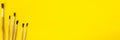 Banner with a yellow background. Paints and brushes for painting. School office. Royalty Free Stock Photo