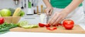 Banner. young pretty woman in green shirt cutting cooking and knife preparing fresh vegetables salad for good healthy in kitchen a Royalty Free Stock Photo