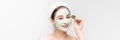 Young girl with a cleansing cosmetic mask on her face poses with a green leaf. Banner Royalty Free Stock Photo