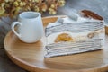 Banoffee banana cake with cocoa powder on wooden plate