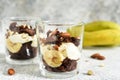 Banoffi pie in a glass on a concrete background. Dessert in a glass.