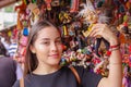 BANOS, ECUADOR, AUGUST, 17, 2018: Beautiful young woman holding in her hands a handmade toy gnomo at a craft store in