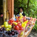 Local tropical fruits for sale with indigenous Ecuadorian man in background, selective focus
