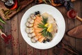 Assorted smoked fish platter on wooden background Royalty Free Stock Photo