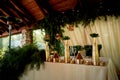 Banquet hall in the open air with a wooden ceiling, hanging garlands.Eco design.