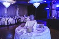 Banquet hall before party. Tableware and tablecloth arrangement in interior of modern ceremony room. Luxury place for wedding, Royalty Free Stock Photo