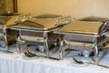 Banquet table with chafing dish heaters Royalty Free Stock Photo