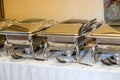 Banquet table with chafing dish heaters Royalty Free Stock Photo