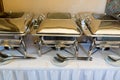 Banquet table with chafing dish heaters Royalty Free Stock Photo