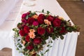 Banquet table decorated with red dahlias and another flowers.