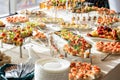 Banquet table dinner restaurant hall dishes with simple decorative sandwiches white tablecloth surface Royalty Free Stock Photo