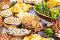 Banquet table with meat products, pistachios, olives, dried fish, chips and other snacks Royalty Free Stock Photo