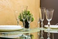 Banquet table served with instruments and decorated with empty wine glasses