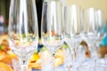 Banquet table served with instruments and decorated with empty wine glasses