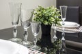 Banquet table served with instruments and decorated with empty wine glasses