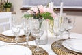 Banquet table served with instruments and decorated with empty wine glasses