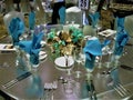 Ballroom table setting with spandex table cover, blue centerpiece and blue napkins