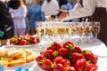 A banquet table with wine glasses and plates with snacks