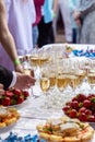 A banquet table with wine glasses and plates with snacks