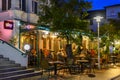 Fully occupied tables and chairs at a restaurant in evening