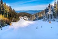 Ski slope in Bansko, Bulgaria and skiers