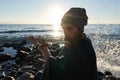 Bansuri player playing music in sunshine at sea shore.