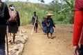 Baduy Luar people walk towards the fields.